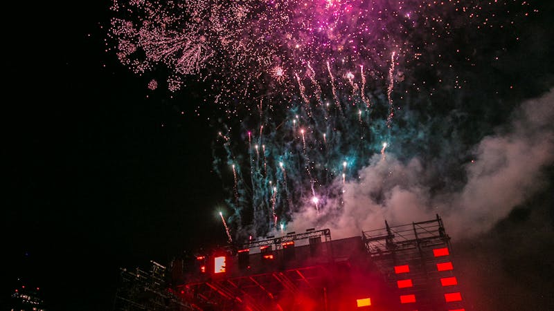 DJ profesional en cabina con controladora y luces de evento — precios de DJ en España 2026